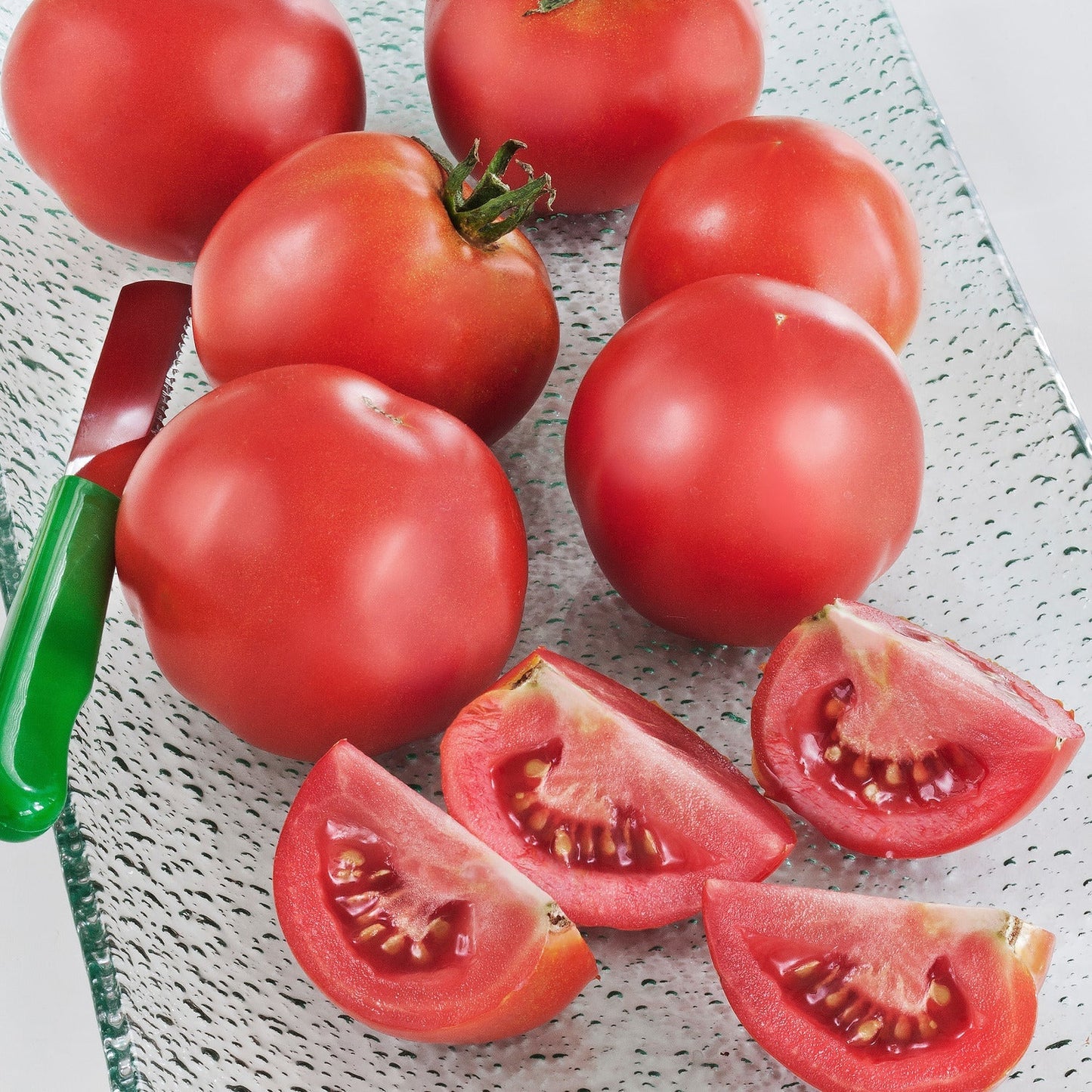 When gardeners talk about the "first" tomatoes, Early Girl is always there. This may be the most all-round popular hybrid to satisfy that itch for the first fresh tomato of the season. Use them for slicing on a place, into a salad, or on a sandwich. This a proven all-round early hybrid. Use it to jump start your harvest. Early Girl bears lots of fruit for early harvest, but because the vines are indeterminate, they continue producing through summer. In our Alabama test garden, where conditions are ideal an